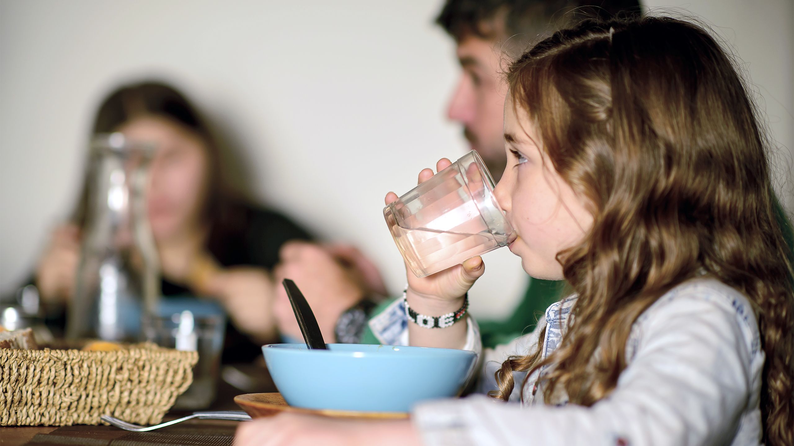 A girl drinks a glass of water